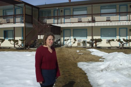 Paula Harned stands in front of the newly renovated suites at the Christina Lake Village; Photo, Anisah Madden