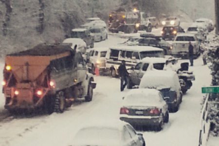 Coastal-like snowfall causes vehicles to play bumper cars on Cedar Street in Nelson